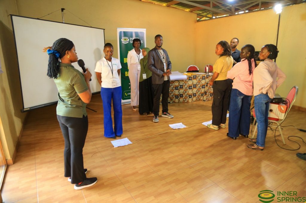 An InnerSprings facilitator with a microphone leading a group activity at a workshop